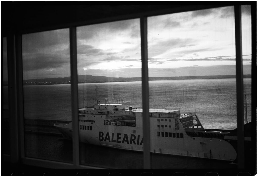 A black and white photo of a ferry boat